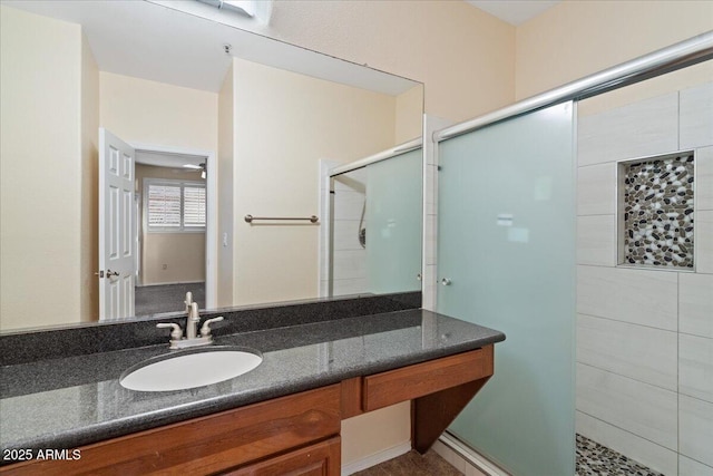 full bathroom with a stall shower and vanity