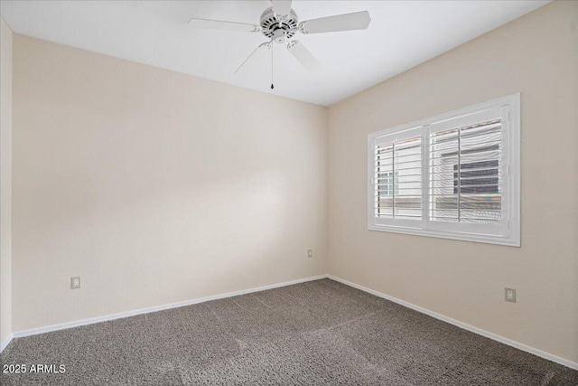 carpeted spare room featuring baseboards and ceiling fan