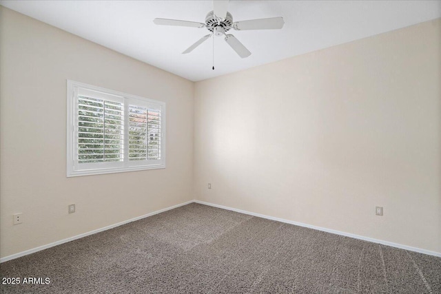 carpeted spare room with ceiling fan and baseboards