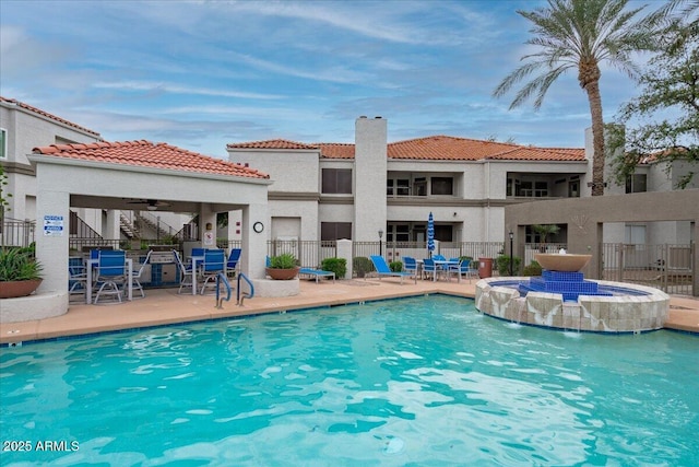 view of pool featuring a patio area and fence