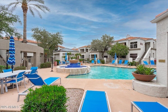 view of swimming pool with a patio area and fence