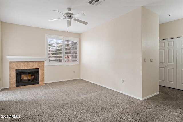 unfurnished living room with baseboards, visible vents, a ceiling fan, and carpet