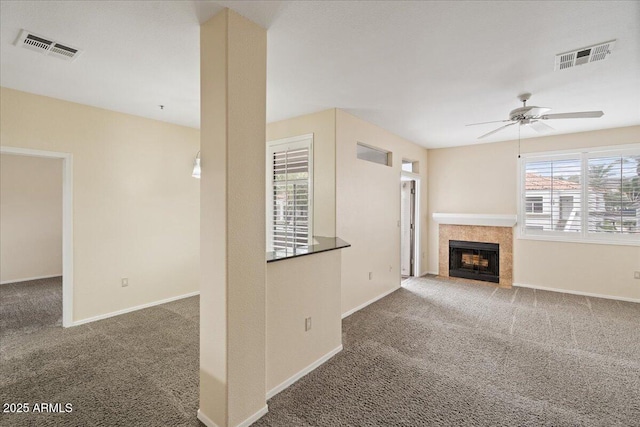 unfurnished living room with visible vents, ceiling fan, and carpet floors