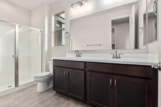 bathroom featuring vanity, toilet, and walk in shower