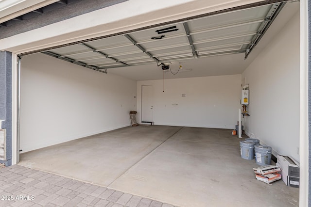 garage featuring a garage door opener and water heater