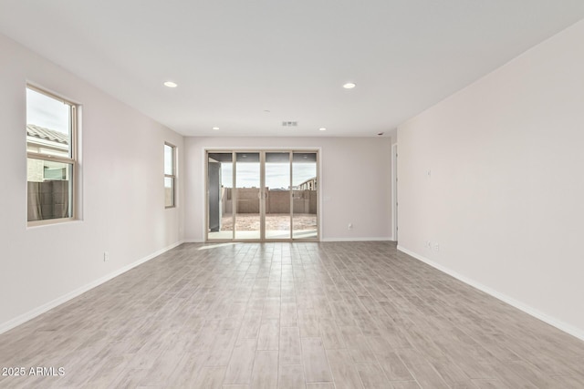 unfurnished room with light hardwood / wood-style floors