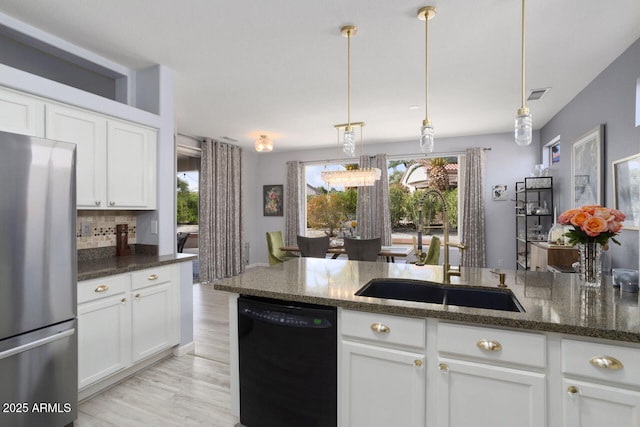 kitchen with white cabinetry, dishwasher, pendant lighting, and stainless steel refrigerator