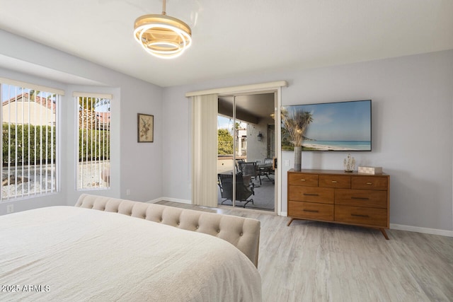 bedroom with access to outside and light hardwood / wood-style floors