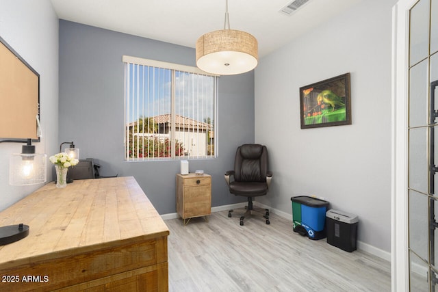 office with light wood-type flooring