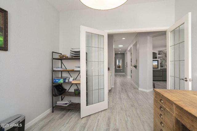 hallway featuring light hardwood / wood-style flooring and french doors