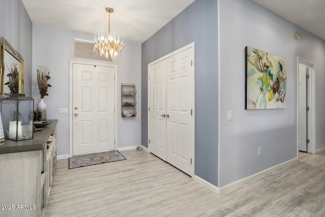 entryway with an inviting chandelier and light hardwood / wood-style floors