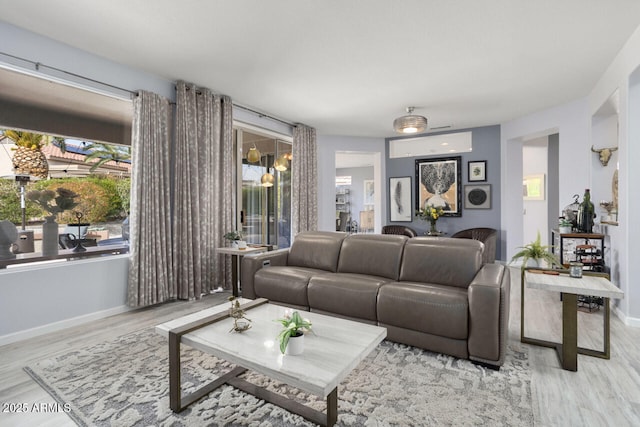 living room with a wealth of natural light and light wood-type flooring