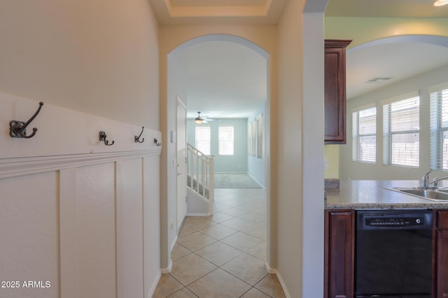 corridor with sink and light tile patterned flooring