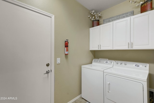 washroom featuring cabinets and independent washer and dryer