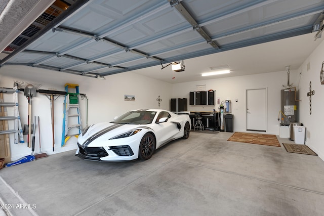 garage featuring water heater and a garage door opener