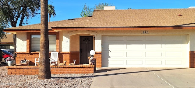 view of front of house with a shingled roof, driveway, an attached garage, and stucco siding