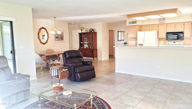 living room featuring a chandelier, visible vents, baseboards, and light tile patterned floors