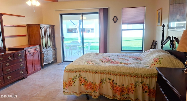 bedroom with light tile patterned floors and access to exterior