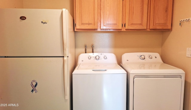 laundry area with washer and dryer and cabinet space