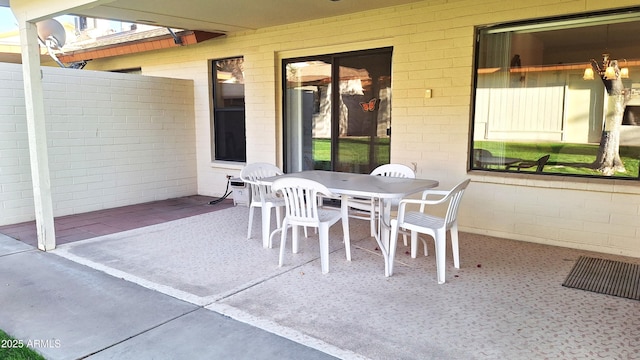 view of patio with outdoor dining area and fence