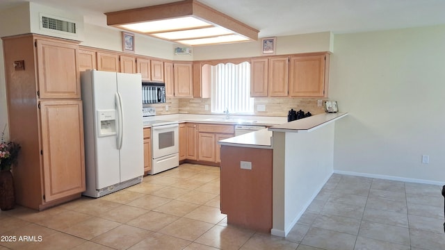 kitchen with white appliances, tasteful backsplash, visible vents, a peninsula, and light brown cabinets