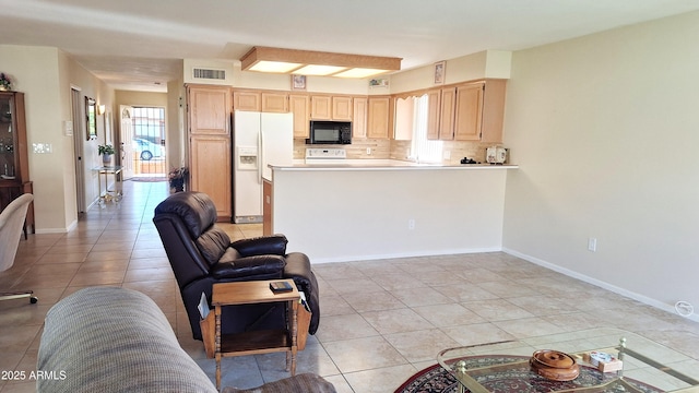 living room featuring visible vents, baseboards, and light tile patterned floors