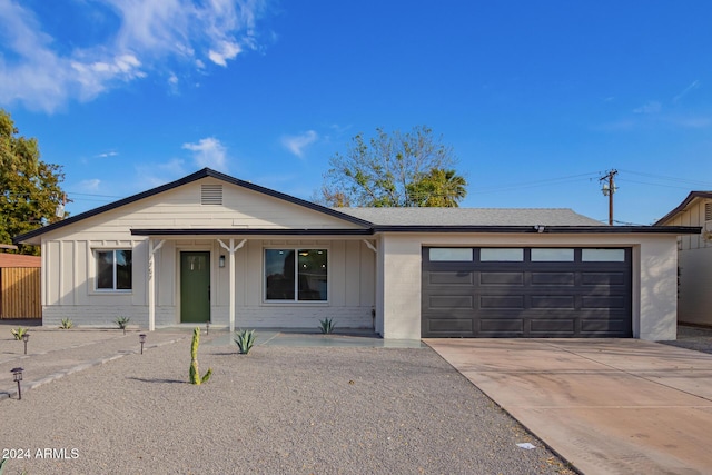 single story home with covered porch and a garage