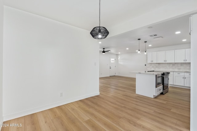 unfurnished living room with ceiling fan and light hardwood / wood-style floors