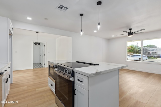 kitchen featuring white cabinetry, light wood-type flooring, electric stove, and light stone counters