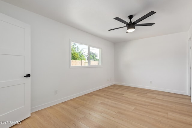 spare room with ceiling fan and light wood-type flooring