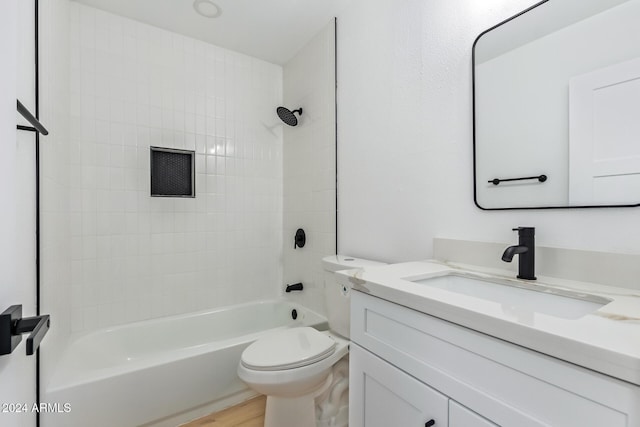 full bathroom featuring hardwood / wood-style floors, vanity, toilet, and tiled shower / bath