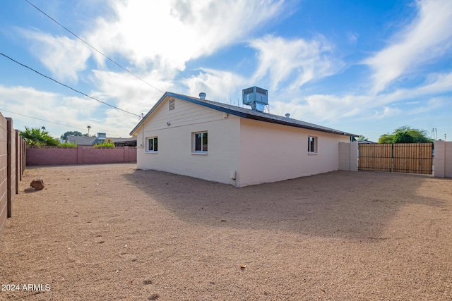 back of house with central air condition unit