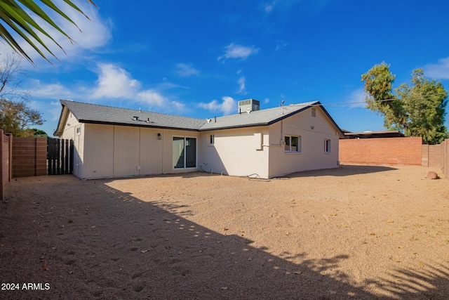 rear view of property featuring central AC unit