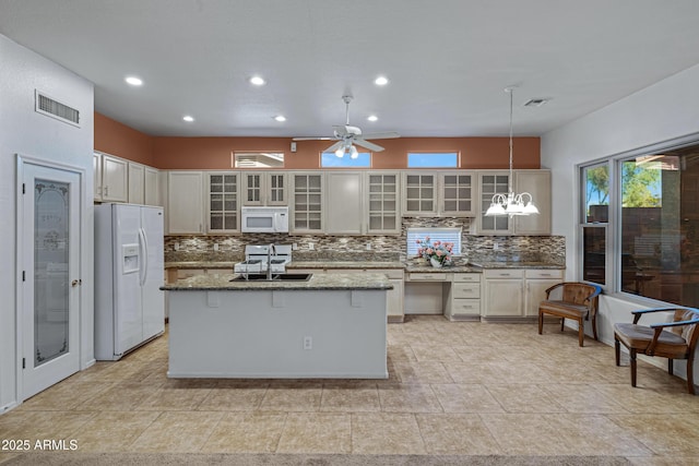 11413 S Coolwater Dr, Goodyear, AZ 85338 - kitchen featuring white appliances, tasteful backsplash, visible vents, and a sink