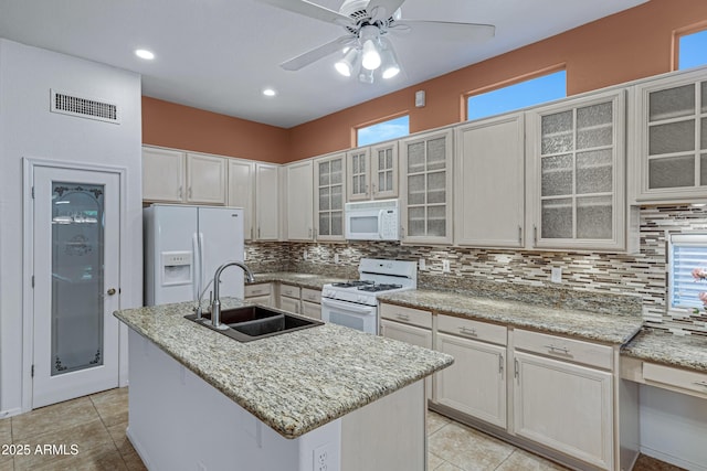11413 S Coolwater Dr, Goodyear, AZ 85338 - kitchen with tasteful backsplash, visible vents, white appliances, a ceiling fan, and a sink