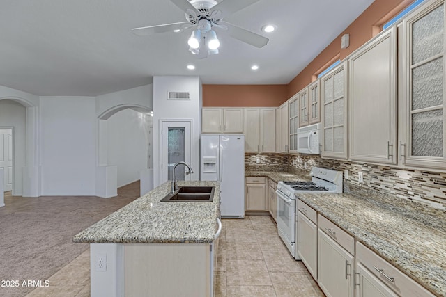 11413 S Coolwater Dr, Goodyear, AZ 85338 - kitchen featuring visible vents, ceiling fan, arched walkways, white appliances, and a sink