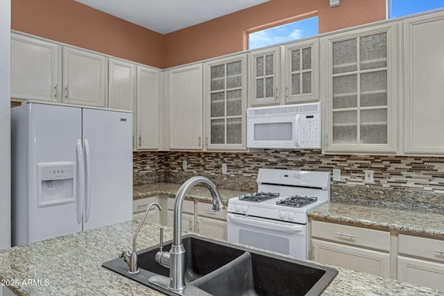 11413 S Coolwater Dr, Goodyear, AZ 85338 - kitchen with decorative backsplash, white appliances, white cabinets, and a sink