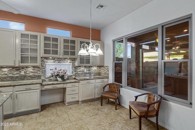 11413 S Coolwater Dr, Goodyear, AZ 85338 - kitchen featuring visible vents, a notable chandelier, pendant lighting, backsplash, and a healthy amount of sunlight