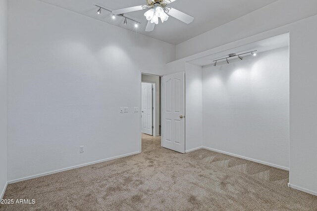 11413 S Coolwater Dr, Goodyear, AZ 85338 - unfurnished room with baseboards, carpet floors, ceiling fan, and track lighting