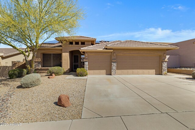11413 S Coolwater Dr, Goodyear, AZ 85338 - prairie-style home featuring stucco siding, driveway, stone siding, an attached garage, and solar panels