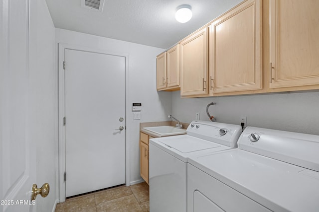 11413 S Coolwater Dr, Goodyear, AZ 85338 - washroom featuring visible vents, washing machine and dryer, cabinet space, a textured ceiling, and a sink