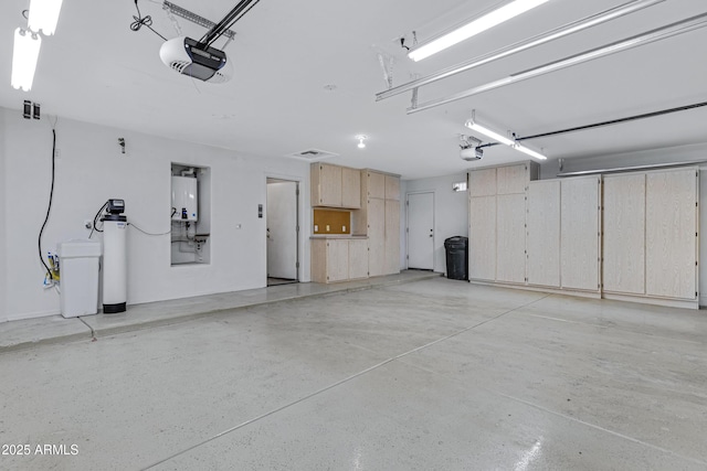 11413 S Coolwater Dr, Goodyear, AZ 85338 - garage featuring tankless water heater and a garage door opener