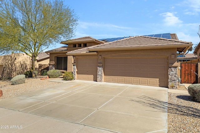 11413 S Coolwater Dr, Goodyear, AZ 85338 - prairie-style home featuring solar panels, a garage, stone siding, and driveway