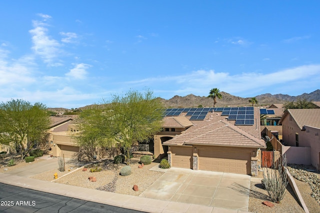 11413 S Coolwater Dr, Goodyear, AZ 85338 - view of front facade featuring an attached garage, concrete driveway, a tile roof, stucco siding, and a mountain view