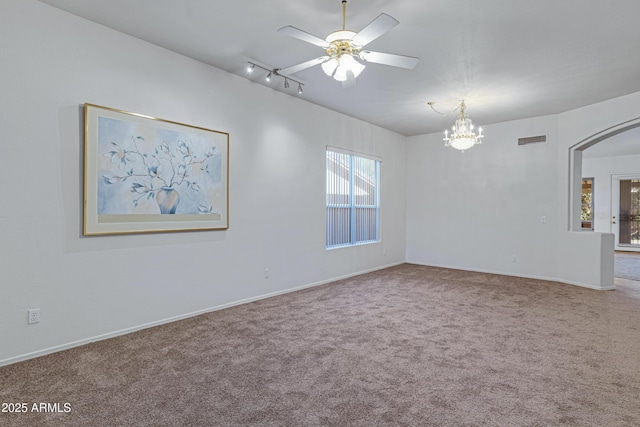11413 S Coolwater Dr, Goodyear, AZ 85338 - spare room featuring visible vents, ceiling fan with notable chandelier, arched walkways, carpet flooring, and baseboards