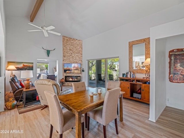 dining space featuring light hardwood / wood-style flooring, high vaulted ceiling, ceiling fan, and beamed ceiling