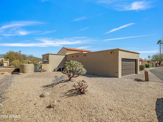 rear view of property with a garage