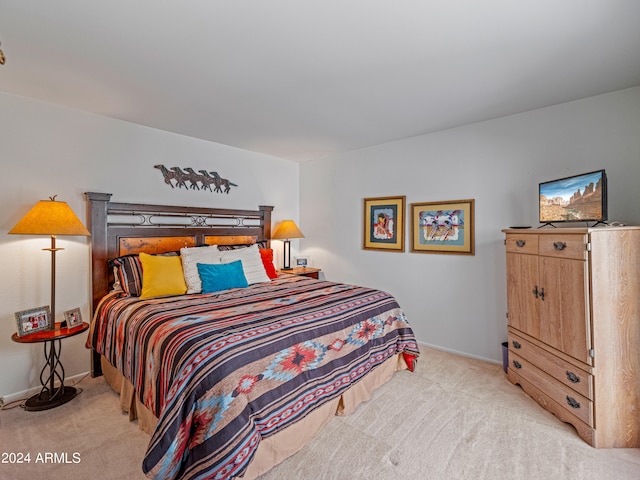 bedroom featuring light carpet