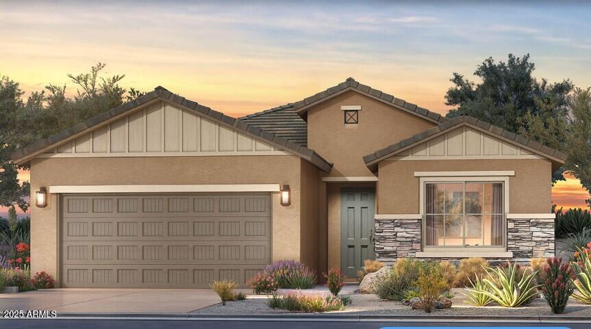 5722 N Maverick Dr, Eloy, AZ 85131 - view of front of home with an attached garage, stucco siding, stone siding, and driveway