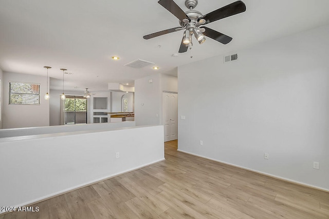 spare room with ceiling fan and light hardwood / wood-style floors